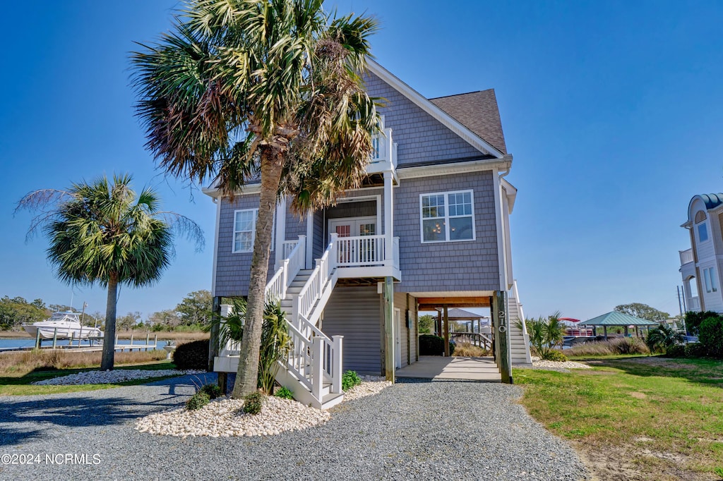 beach home featuring a front lawn