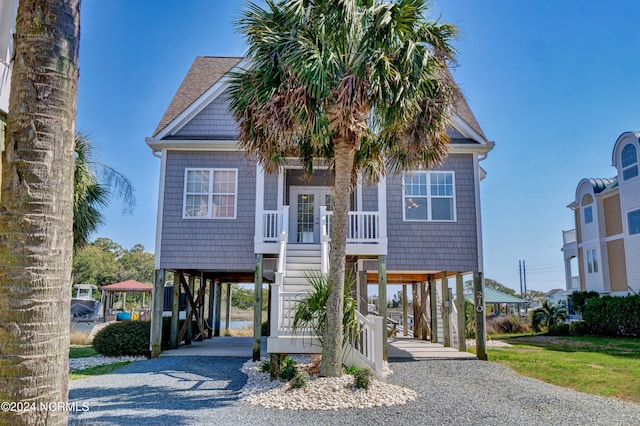 coastal home with a carport and a front yard