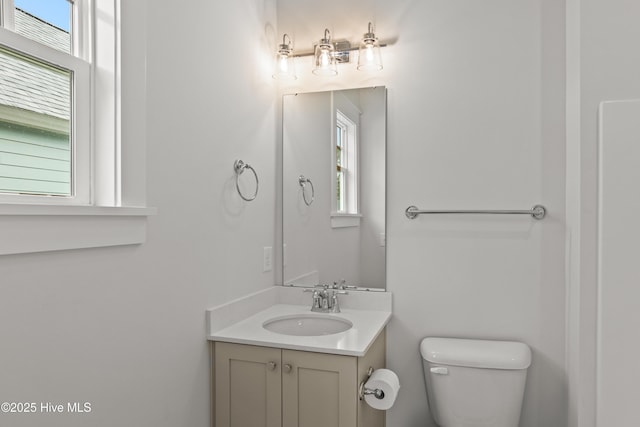 bathroom with toilet and vanity