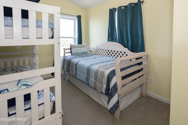 carpeted bedroom with lofted ceiling