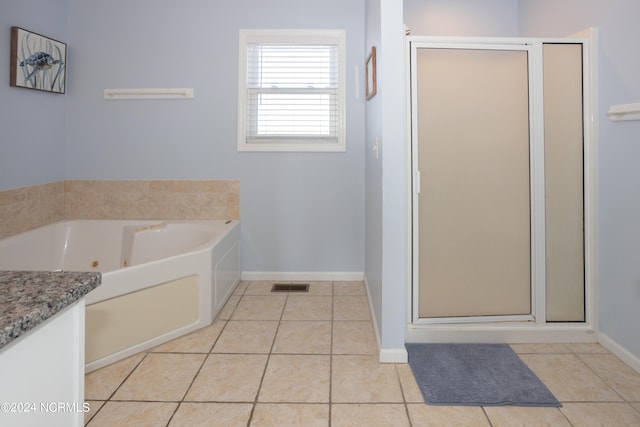 bathroom featuring tile flooring, plus walk in shower, and vanity