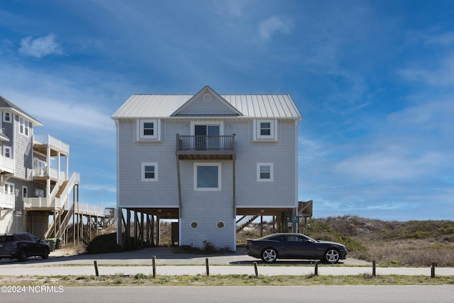 back of property featuring a balcony