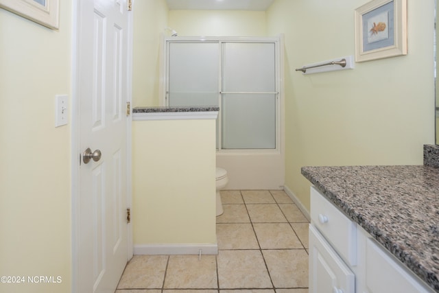 full bathroom with toilet, tile flooring, enclosed tub / shower combo, and vanity