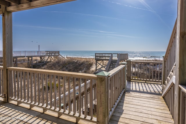 exterior space featuring a deck with water view