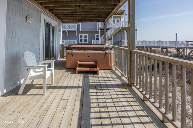 wooden deck with a hot tub