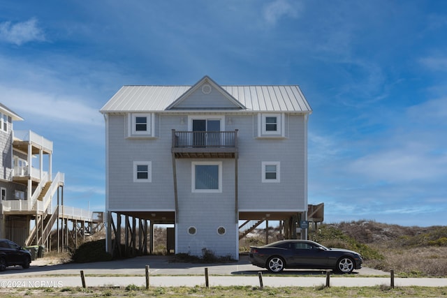 rear view of property with a balcony