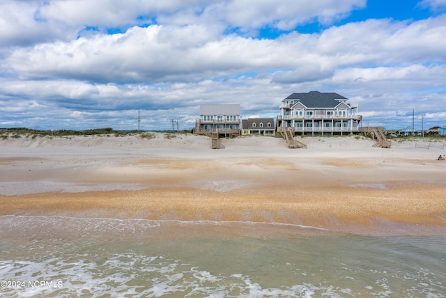 exterior space with a water view and a view of the beach