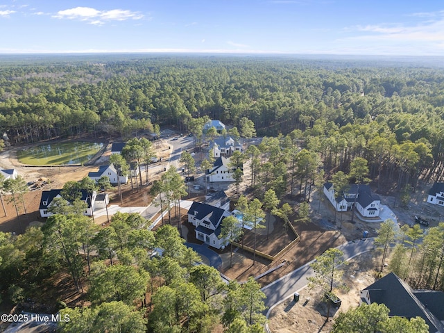 bird's eye view featuring a forest view and a residential view