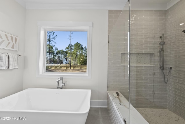 full bath with tiled shower, baseboards, and a freestanding bath