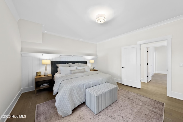 bedroom featuring crown molding, wood finished floors, and baseboards