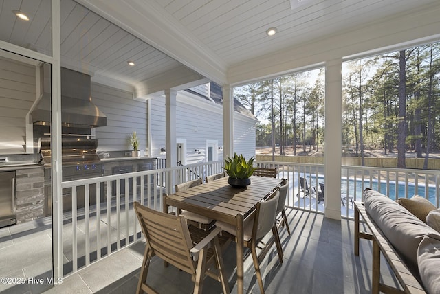 sunroom / solarium featuring beamed ceiling