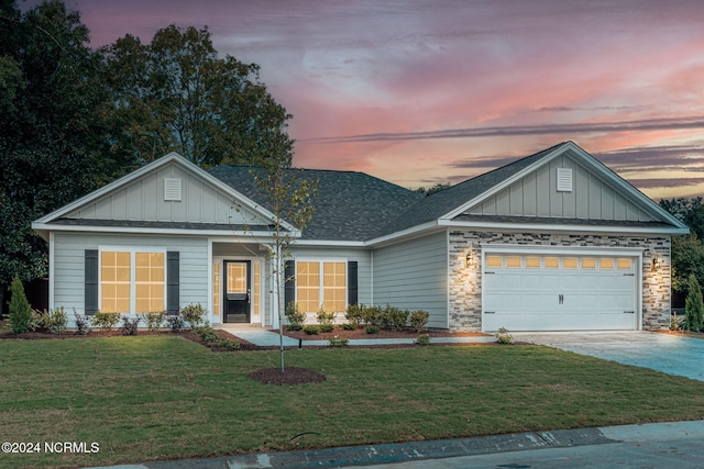 view of front facade with a yard and a garage