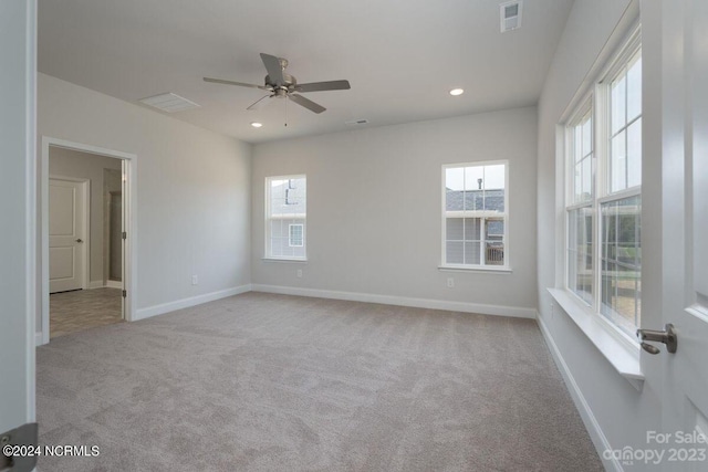 carpeted empty room featuring baseboards, a ceiling fan, visible vents, and recessed lighting