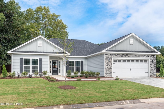 view of front of home featuring board and batten siding, a front lawn, and concrete driveway