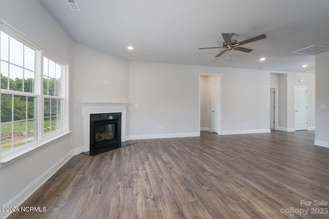 unfurnished living room featuring dark hardwood / wood-style floors and ceiling fan