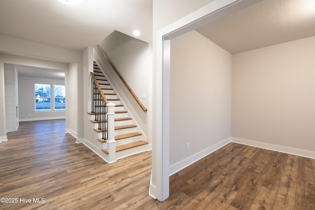 stairs featuring hardwood / wood-style flooring