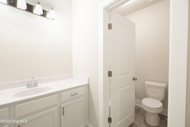 bathroom with toilet and vanity