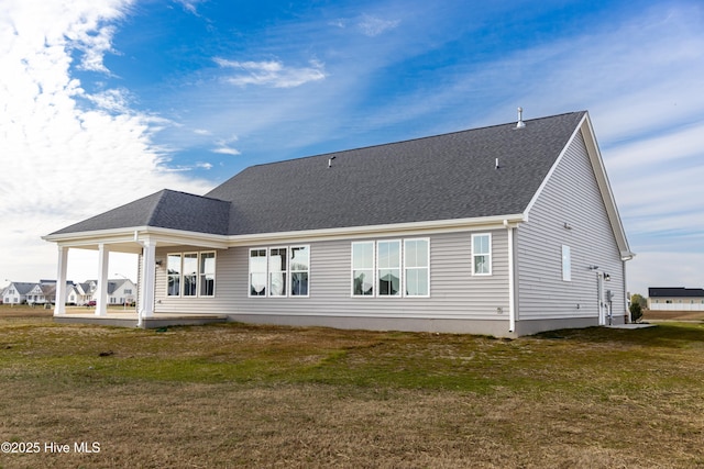 rear view of house with a patio area and a lawn