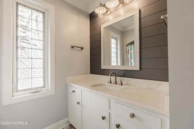 bathroom featuring vanity and ornamental molding