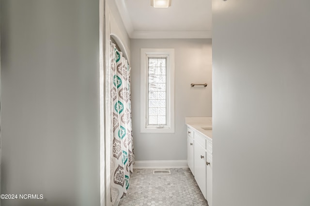 bathroom featuring vanity and crown molding