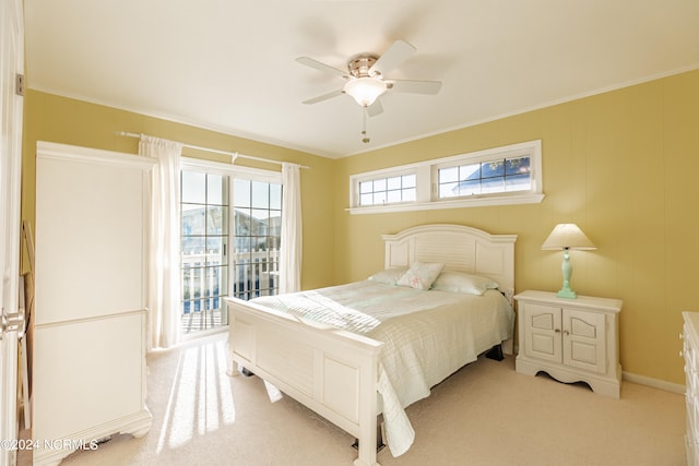 bedroom with ceiling fan, light colored carpet, access to exterior, and crown molding