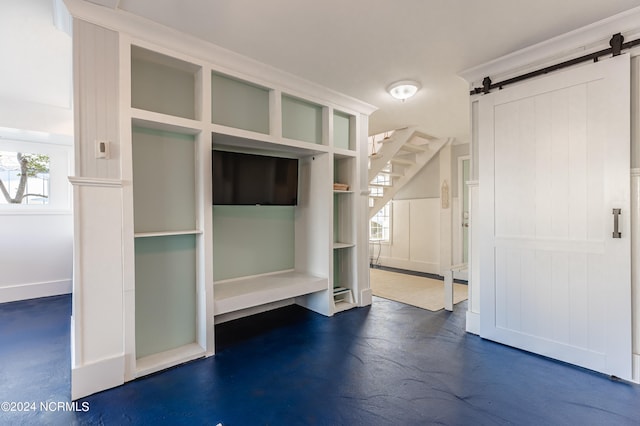 mudroom with plenty of natural light and a barn door