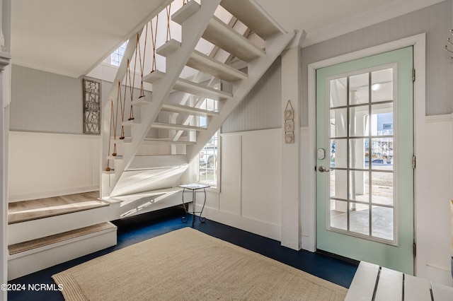 foyer featuring crown molding