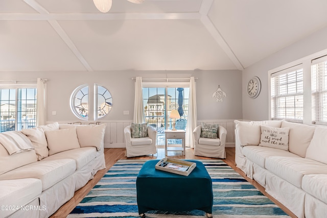 living room with vaulted ceiling, ceiling fan, and hardwood / wood-style flooring