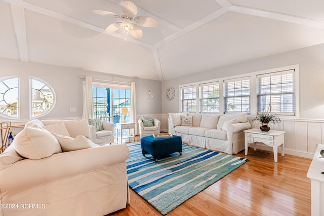 living room featuring wood-type flooring, vaulted ceiling, and ceiling fan