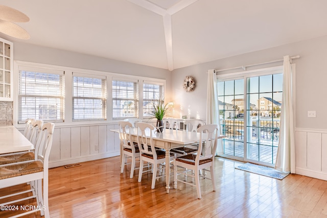 dining area with lofted ceiling and light hardwood / wood-style floors