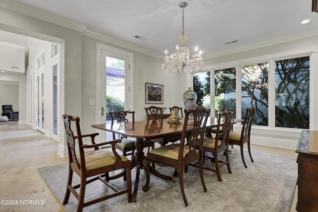 dining space featuring ornamental molding and an inviting chandelier