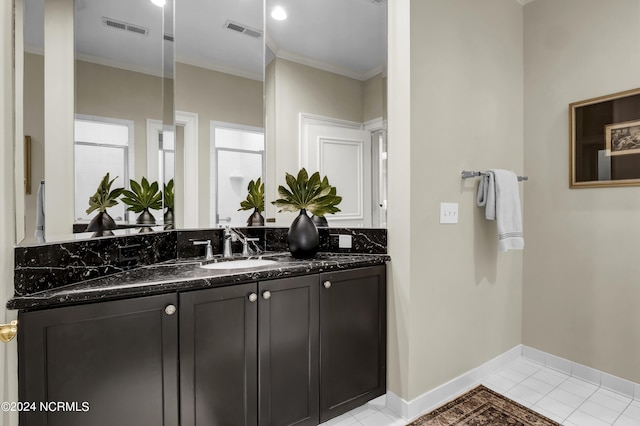 bathroom featuring vanity, ornamental molding, and tile patterned floors