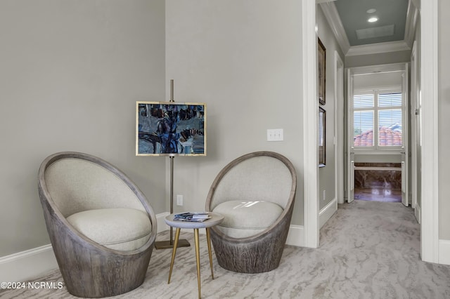 living area featuring crown molding and light carpet