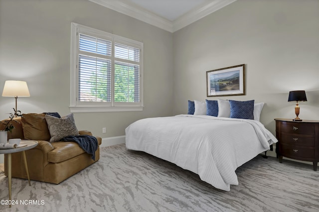 bedroom with ornamental molding and light colored carpet