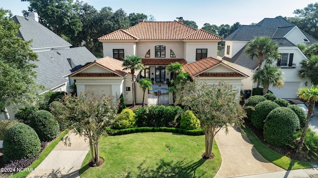 mediterranean / spanish-style home with a front yard