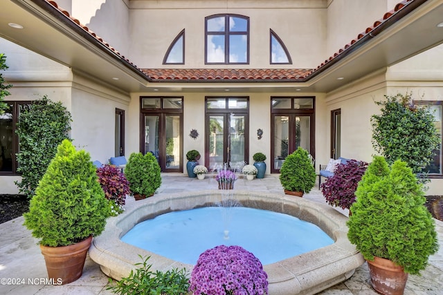 view of swimming pool featuring french doors