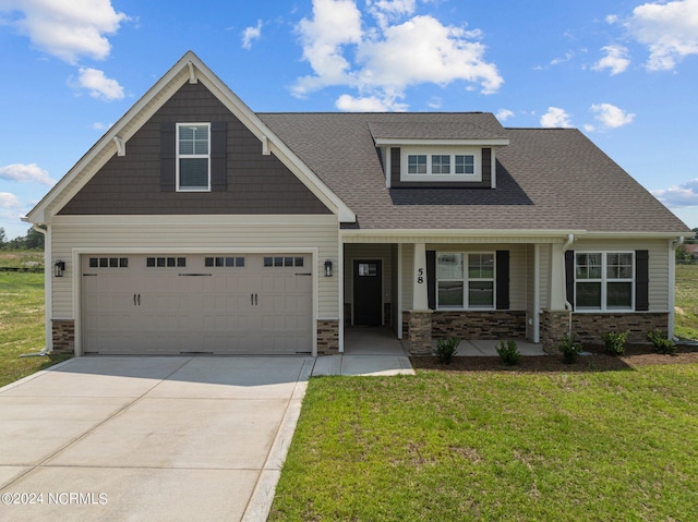 craftsman-style house with a front lawn, a garage, and covered porch