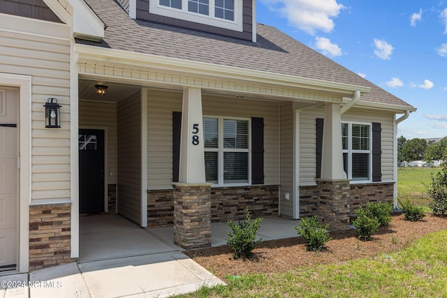 view of exterior entry featuring a porch