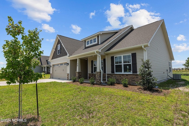 craftsman house with a front yard, a garage, a porch, and central air condition unit