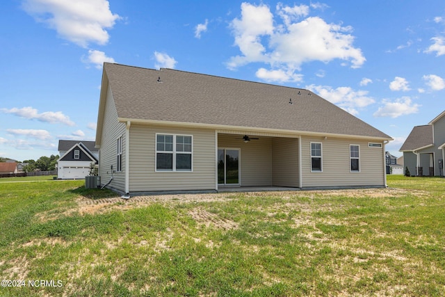 rear view of house featuring ceiling fan, central AC unit, and a lawn