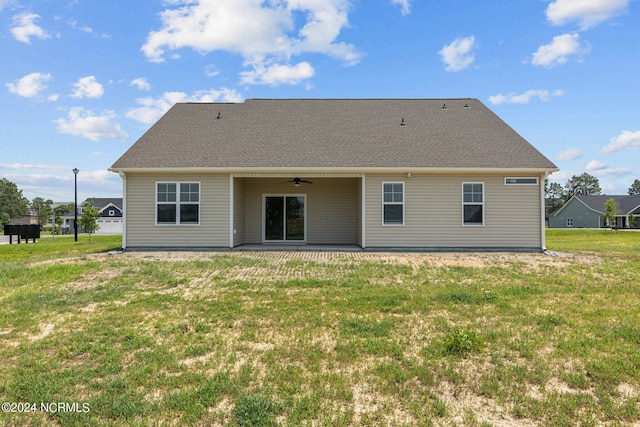 back of property featuring ceiling fan, a patio area, and a lawn