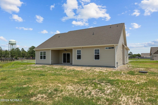 back of house with ceiling fan, a lawn, and a patio