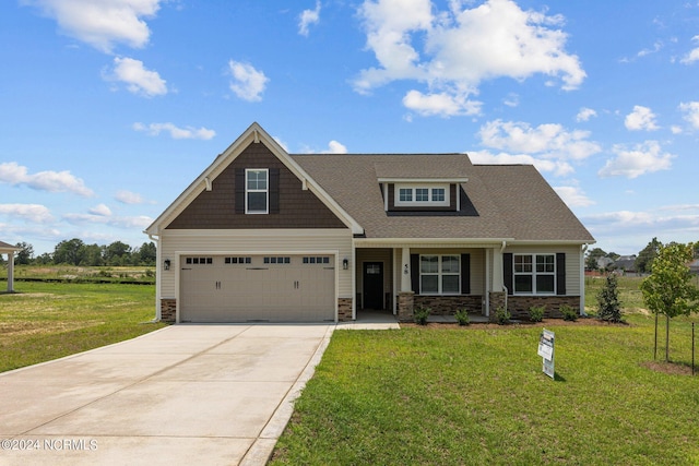 craftsman inspired home featuring a front lawn and a garage