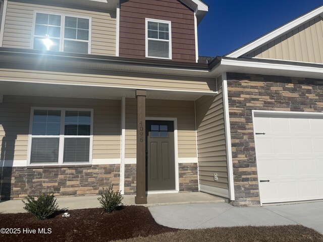 view of exterior entry with a garage