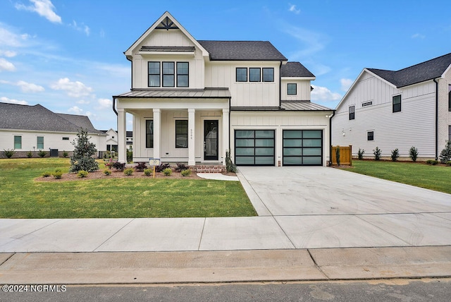 modern farmhouse style home featuring a porch, a front lawn, and a garage