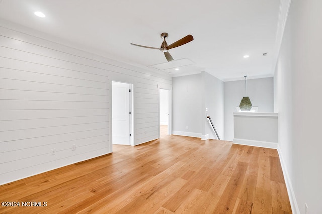 empty room with ceiling fan and light wood-type flooring