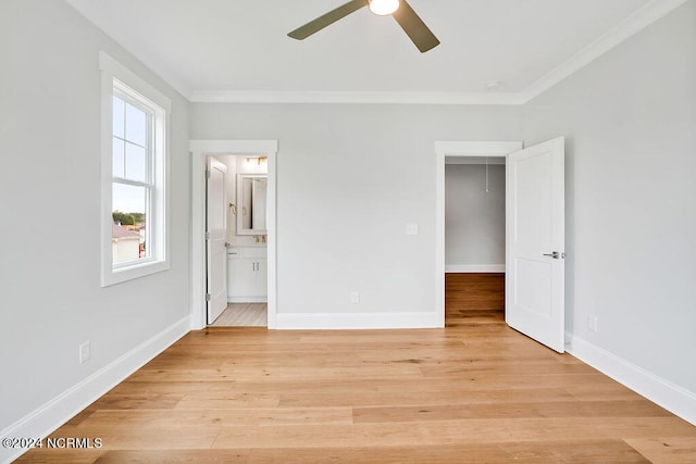 unfurnished bedroom with crown molding, ceiling fan, connected bathroom, a closet, and light hardwood / wood-style flooring