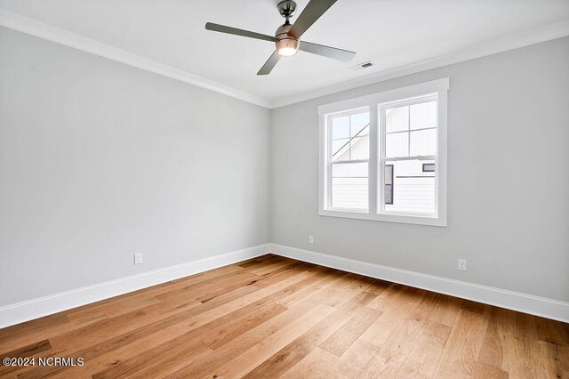 spare room featuring crown molding, ceiling fan, and light hardwood / wood-style flooring