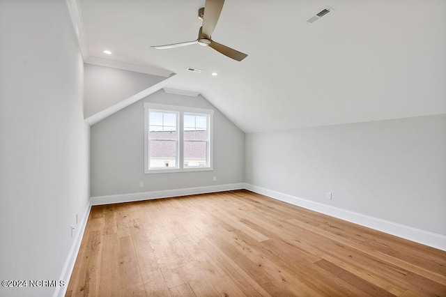 additional living space featuring ceiling fan, vaulted ceiling, and light wood-type flooring