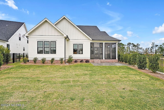 view of front of property with a front yard and a sunroom